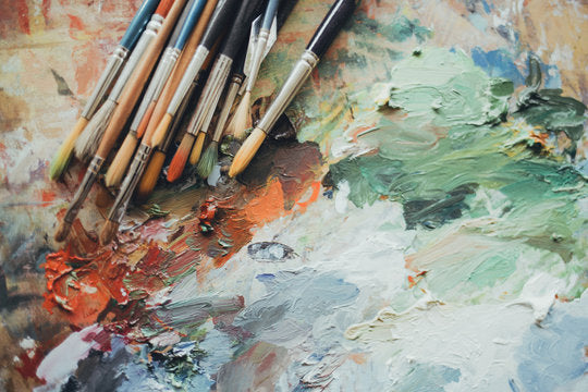 photograph of paintbrushes and paints and an artists' easel